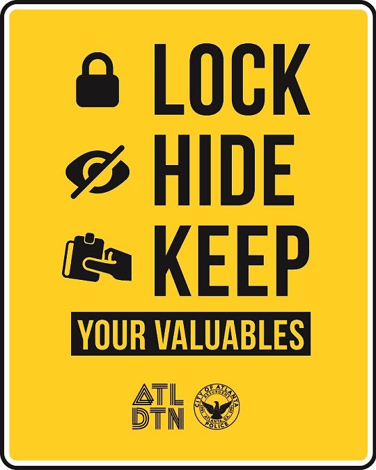 yellow rectangular sign with large black text. text reads Lock Hide Keep Your Valuables